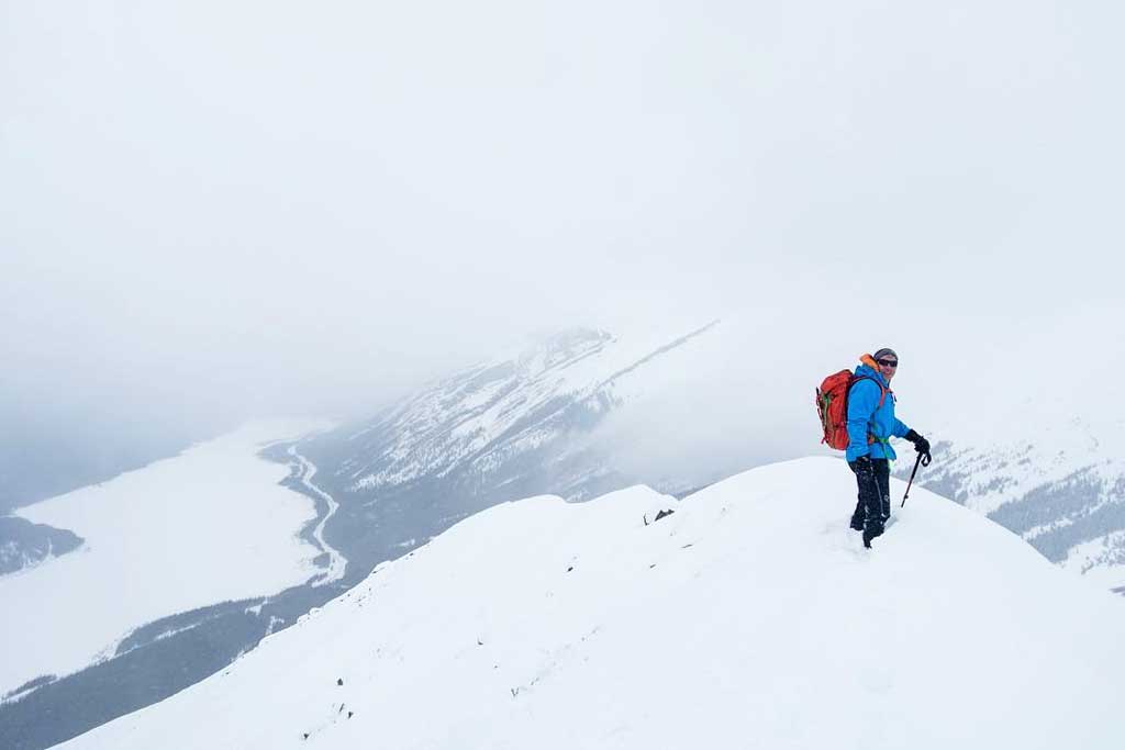 Winter backpacker on snowy mountain peak